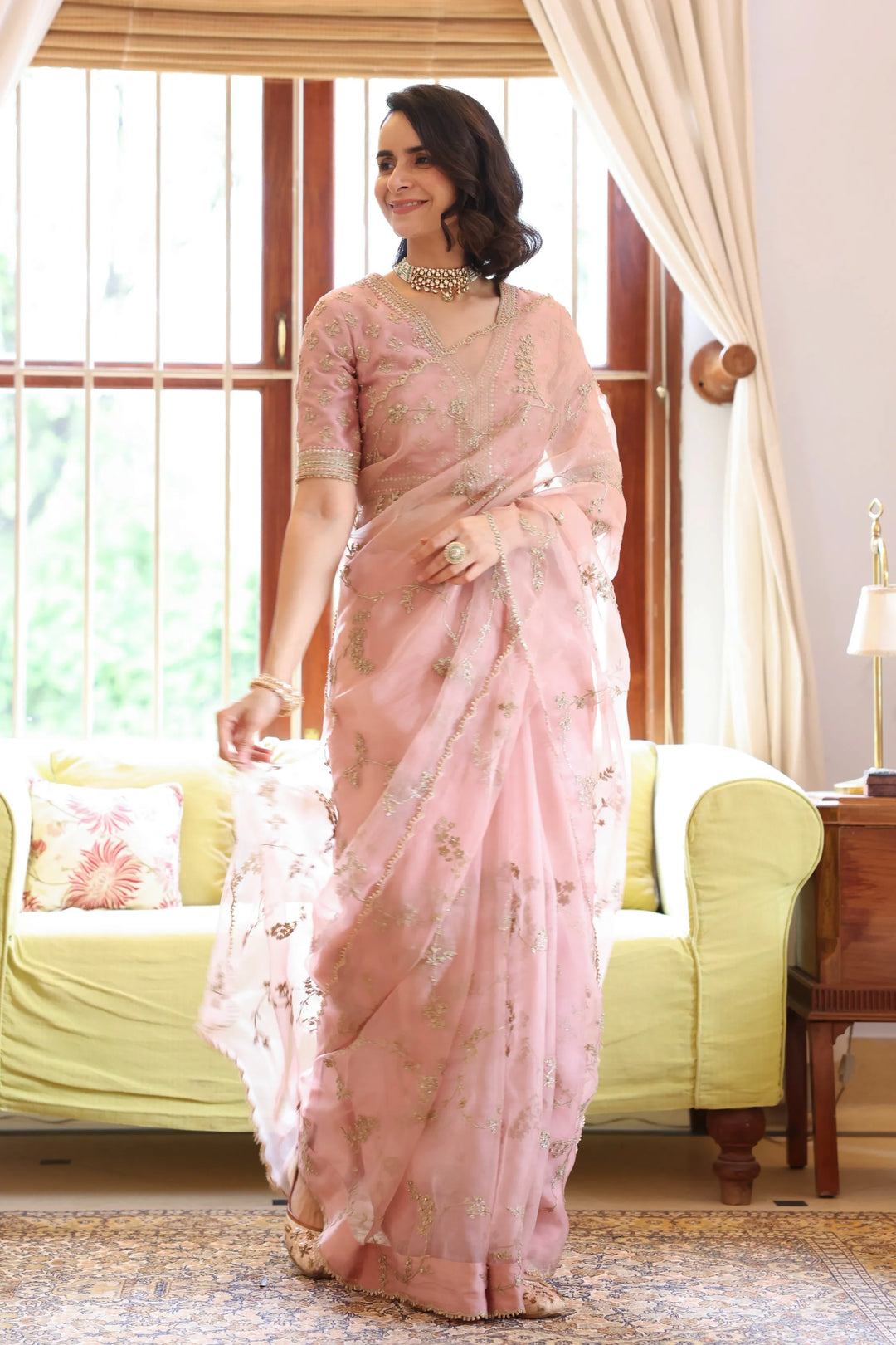 Model in embroidered organza saree with sheer drape