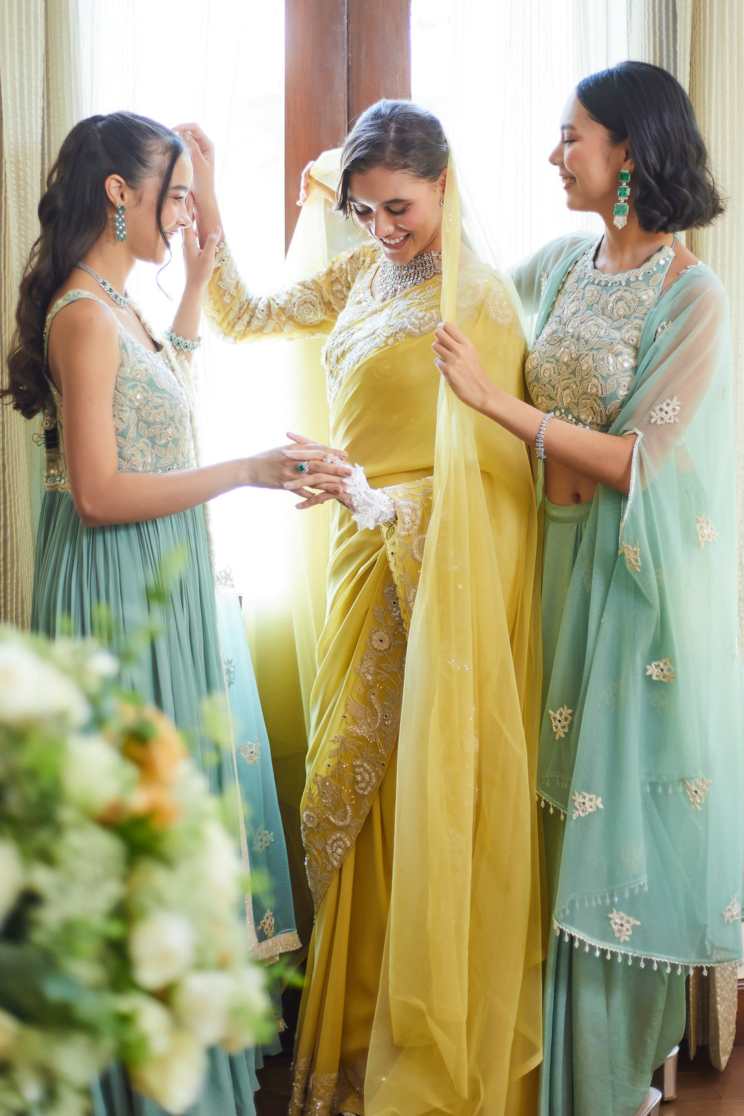 Bridesmaids wearing coordinated embroidered outfits
