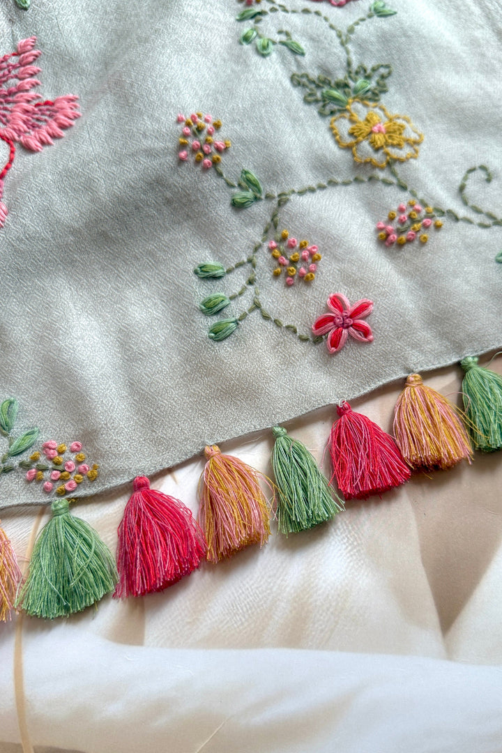 Embroidered fabric with colorful tassels and floral patterns