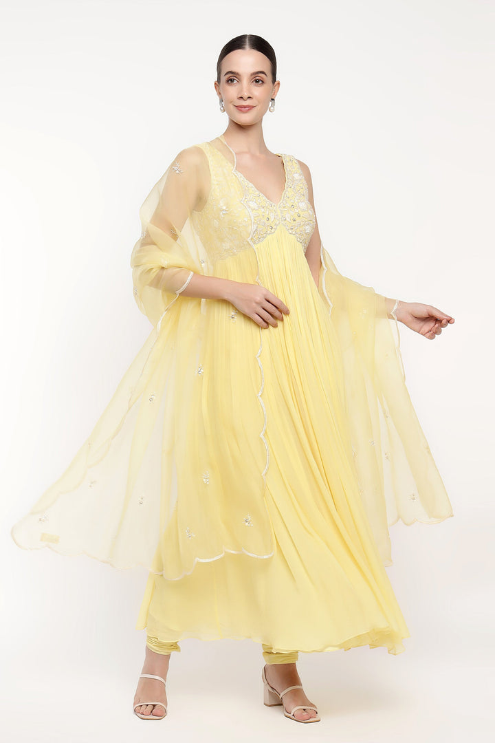 Woman wearing a yellow dress with a white background