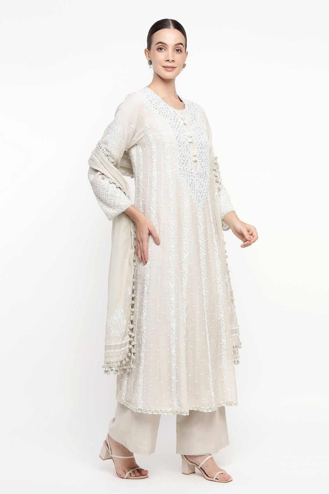 Woman wearing a white traditional outfit with a white background