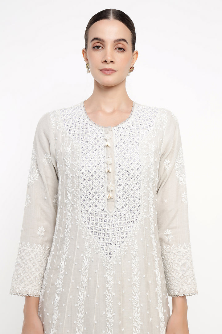 Woman wearing a white lace dress on a white background