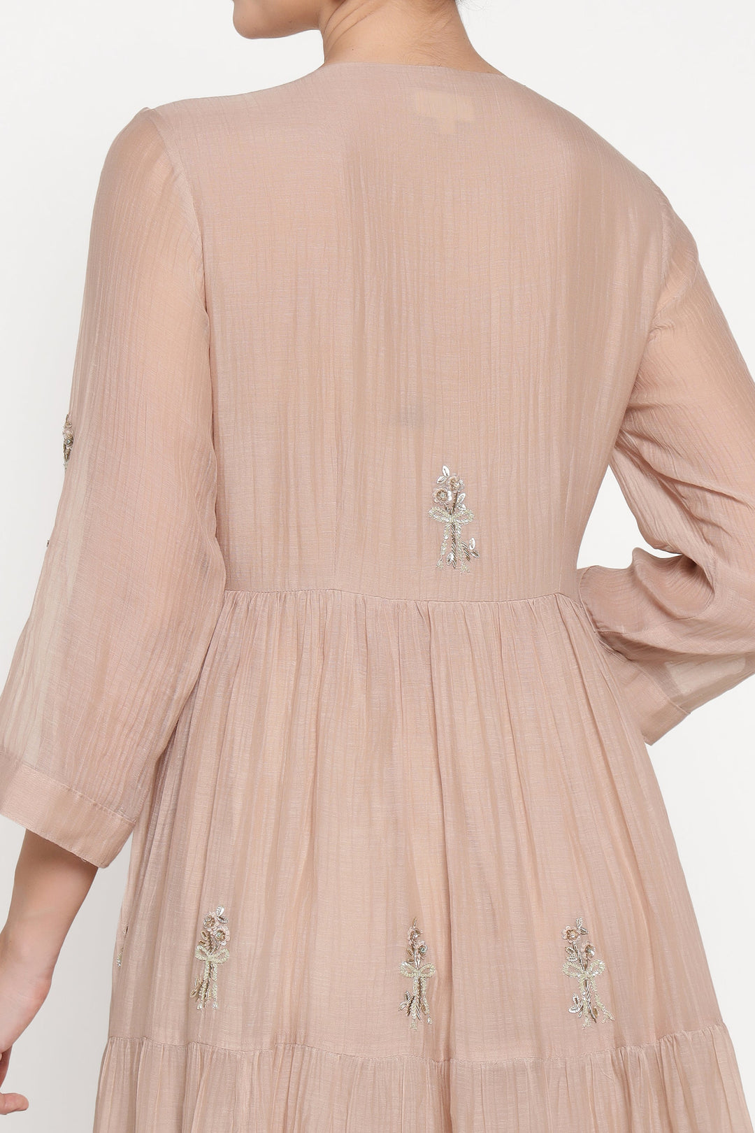 Beige dress with floral embroidery on a white background