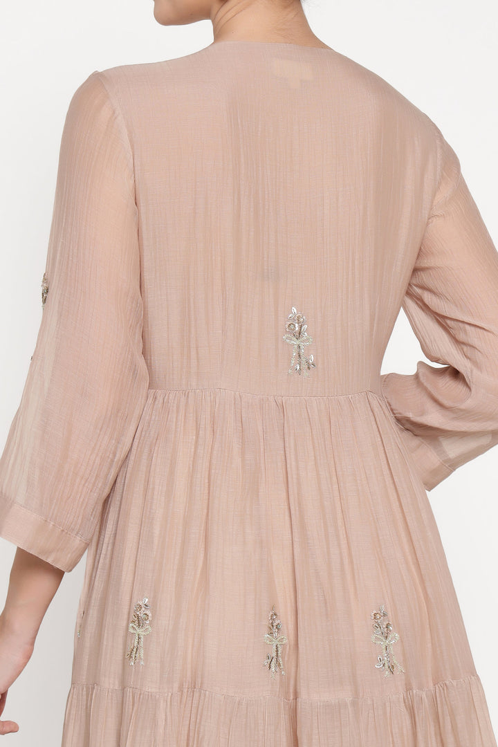 Beige dress with floral embroidery on a white background