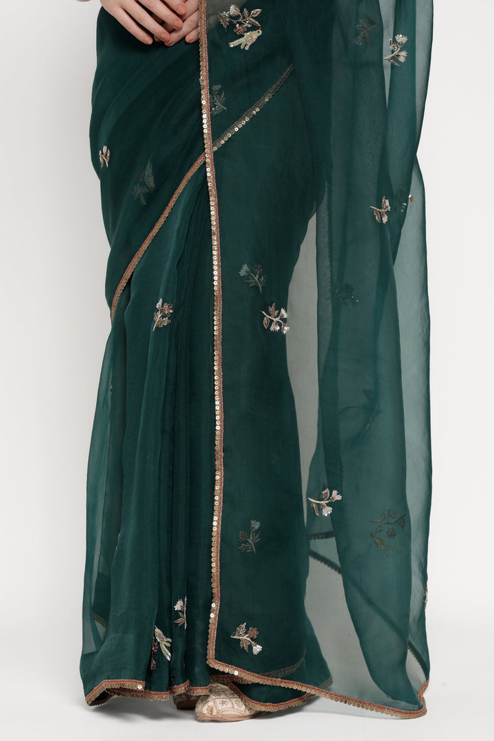 Green saree with floral embroidery on a white background