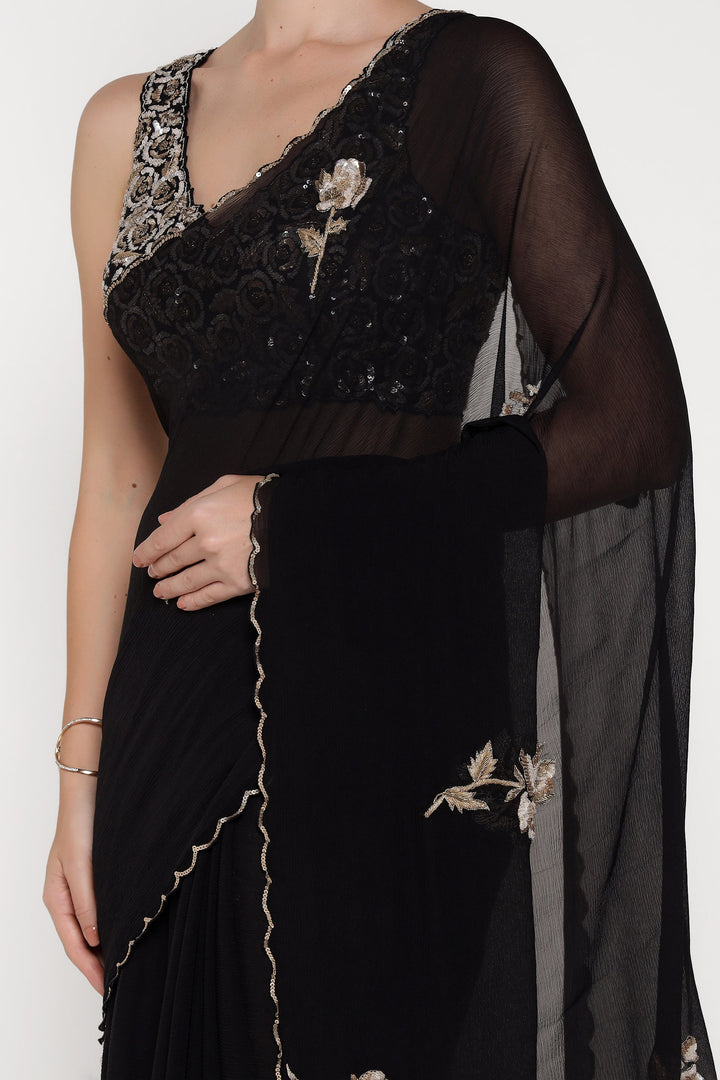 Black saree with floral embroidery on a white background