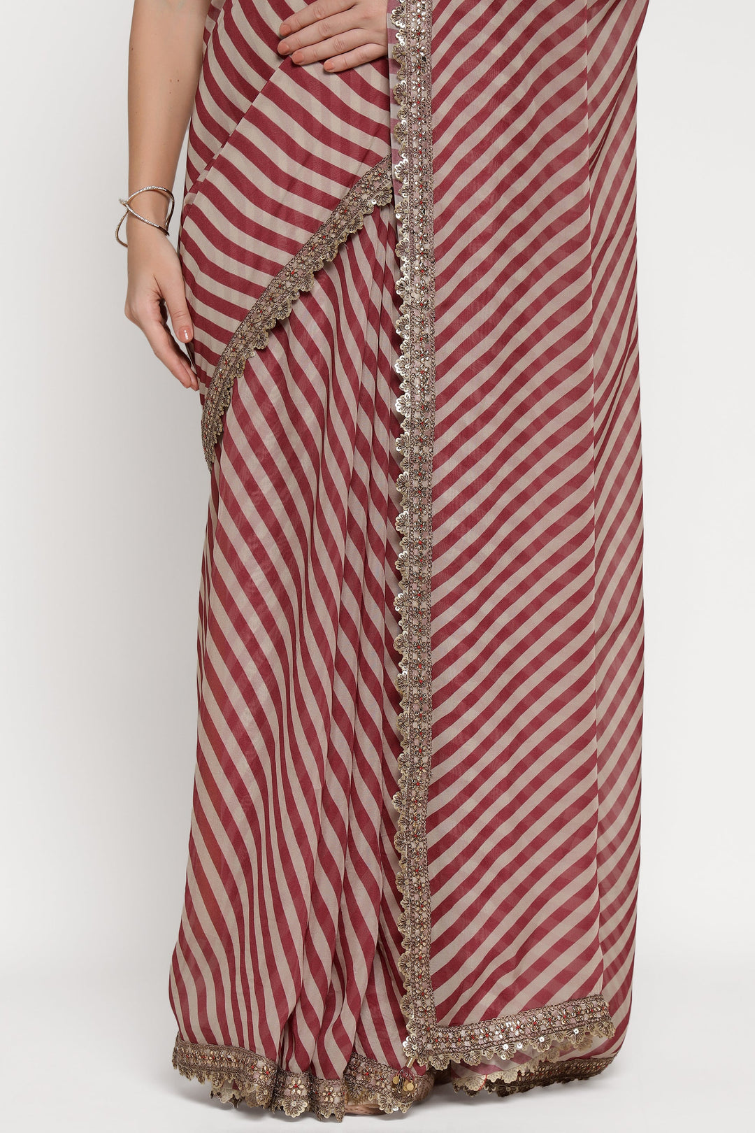 Red and white striped saree with a decorative border on a plain background