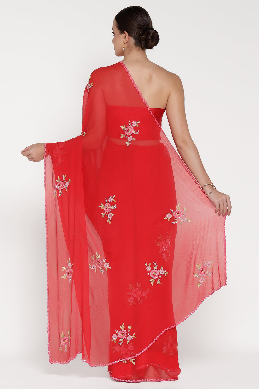 Red saree with floral embroidery on a white background