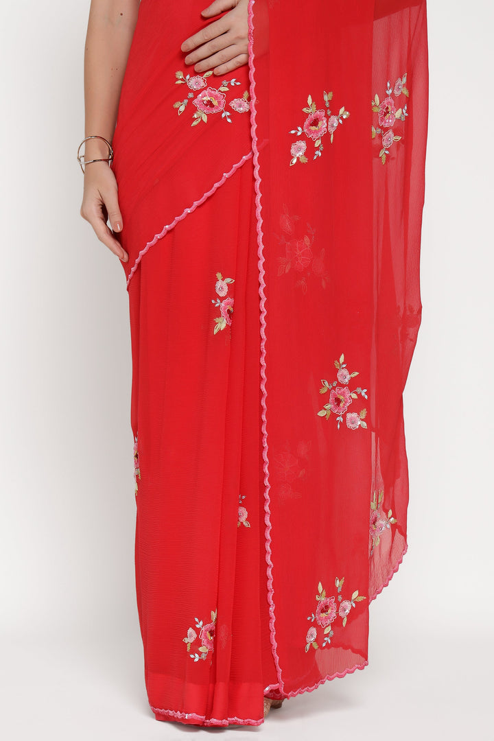 Red saree with floral embroidery on a white background