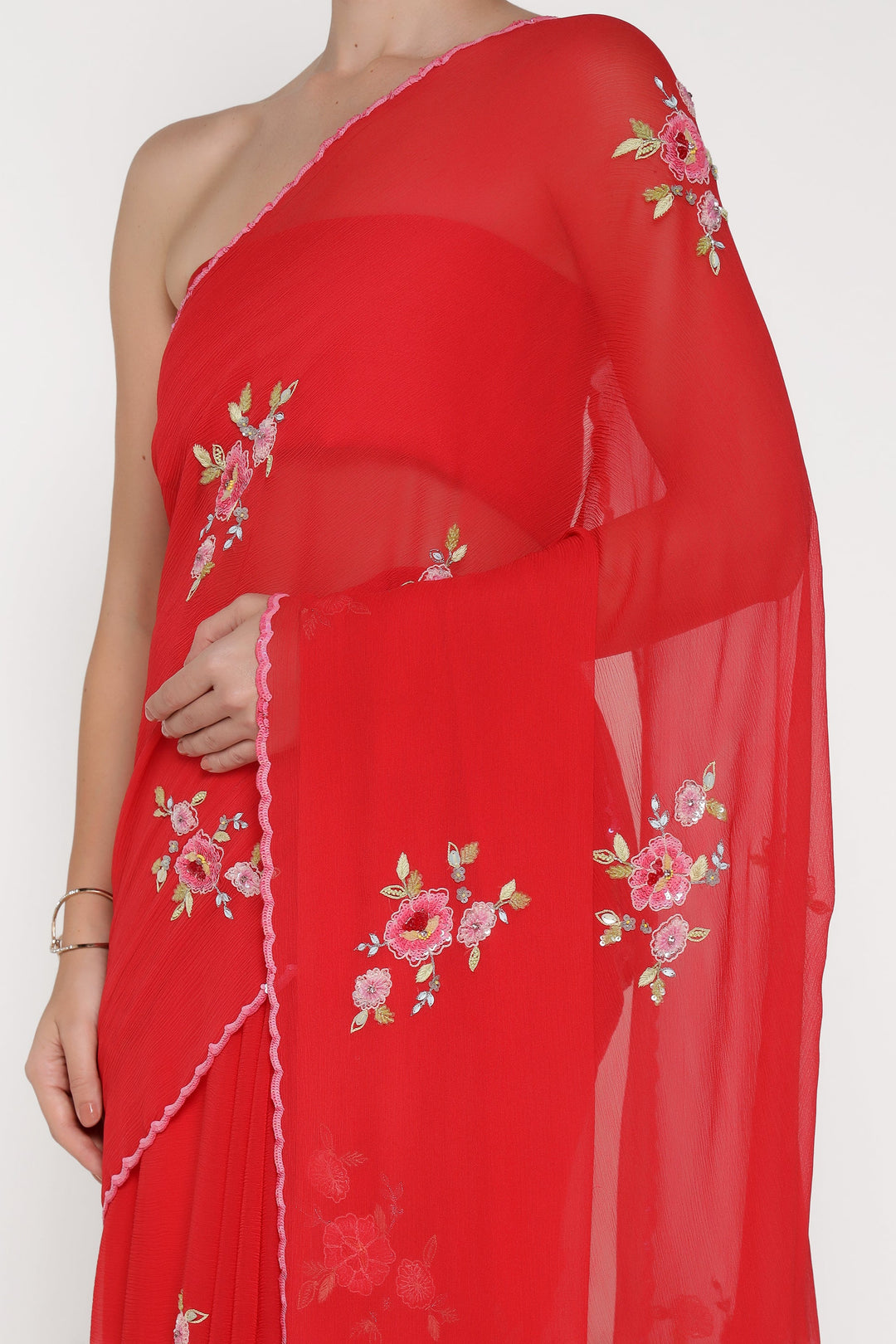 Red saree with floral embroidery on a white background