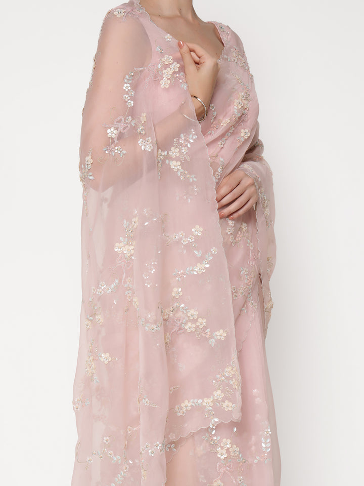 Pink floral embroidered sheer fabric on a white background