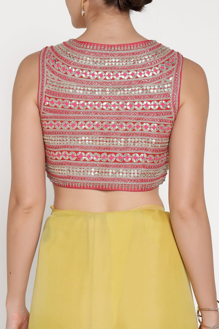 Woman wearing a patterned blouse with a plain background