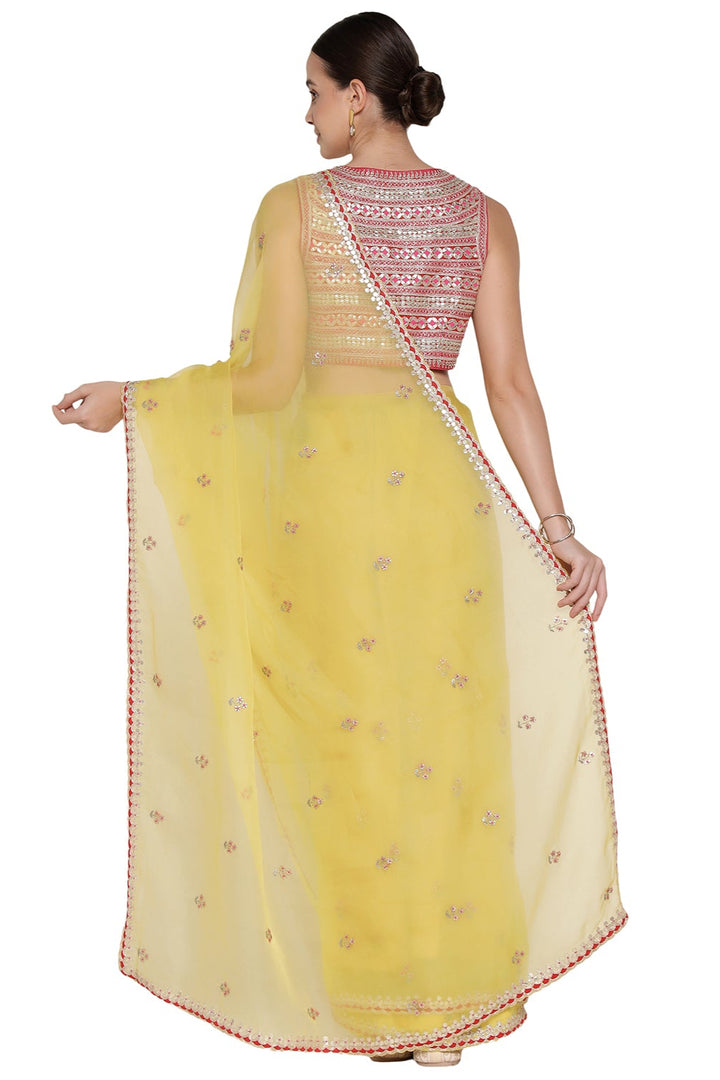 Woman wearing a yellow saree with a white background