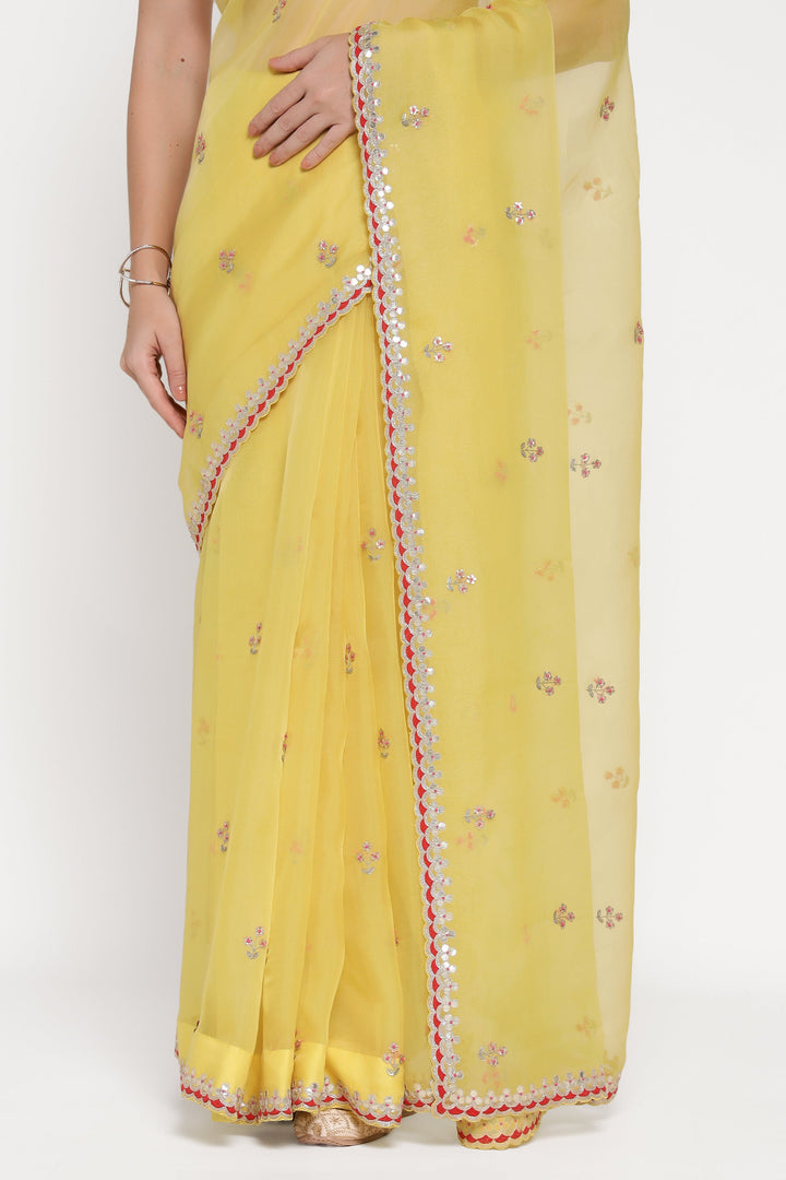 Yellow saree with floral patterns on a white background