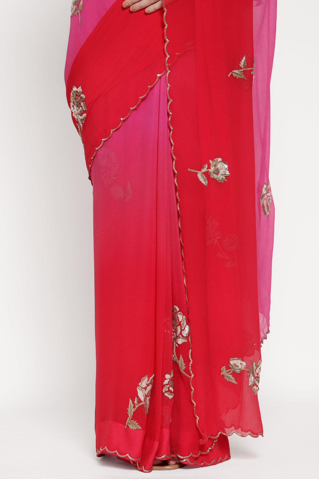 Red saree with floral embroidery on a white background