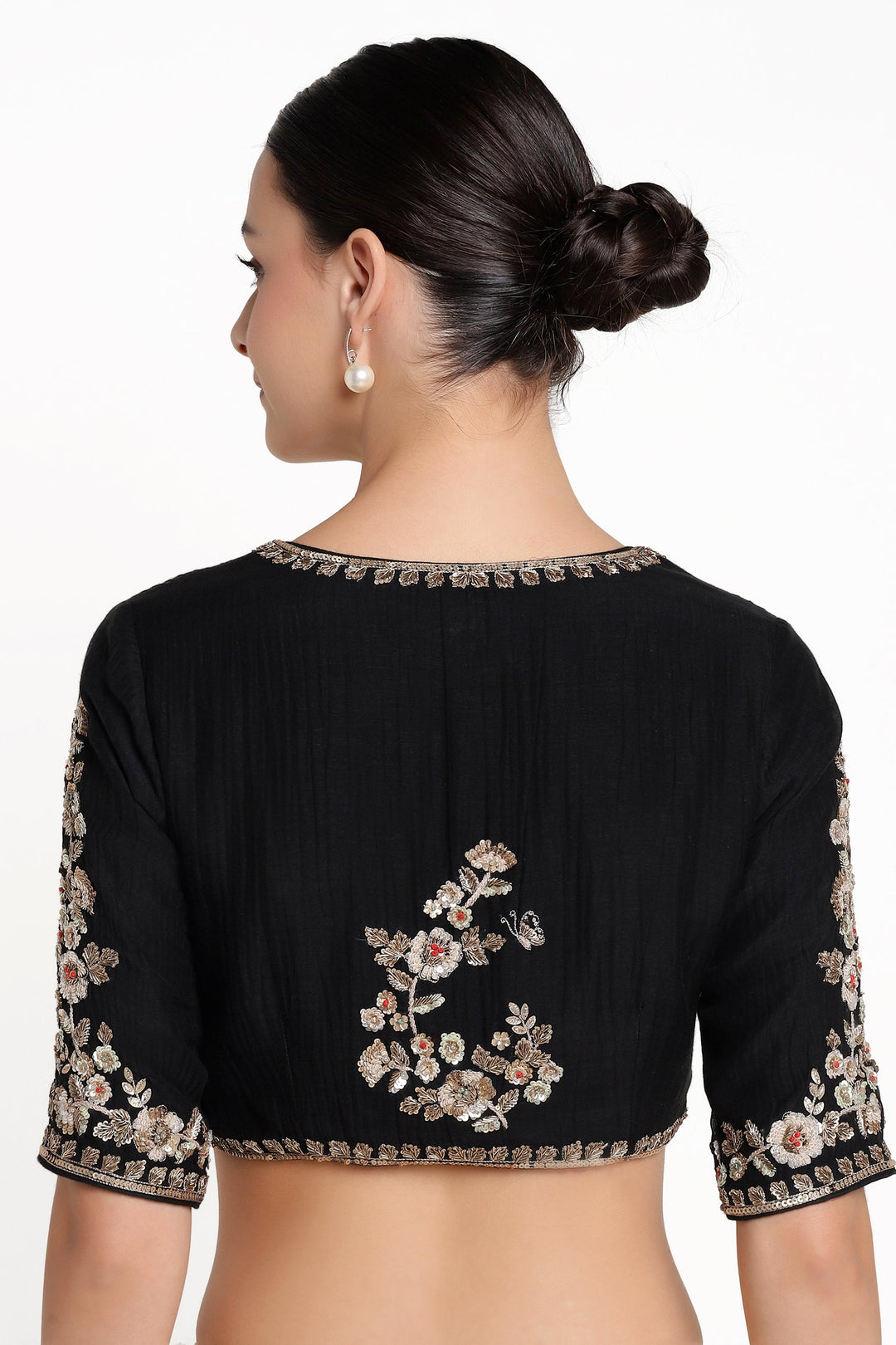 Black blouse with floral embroidery on a white background