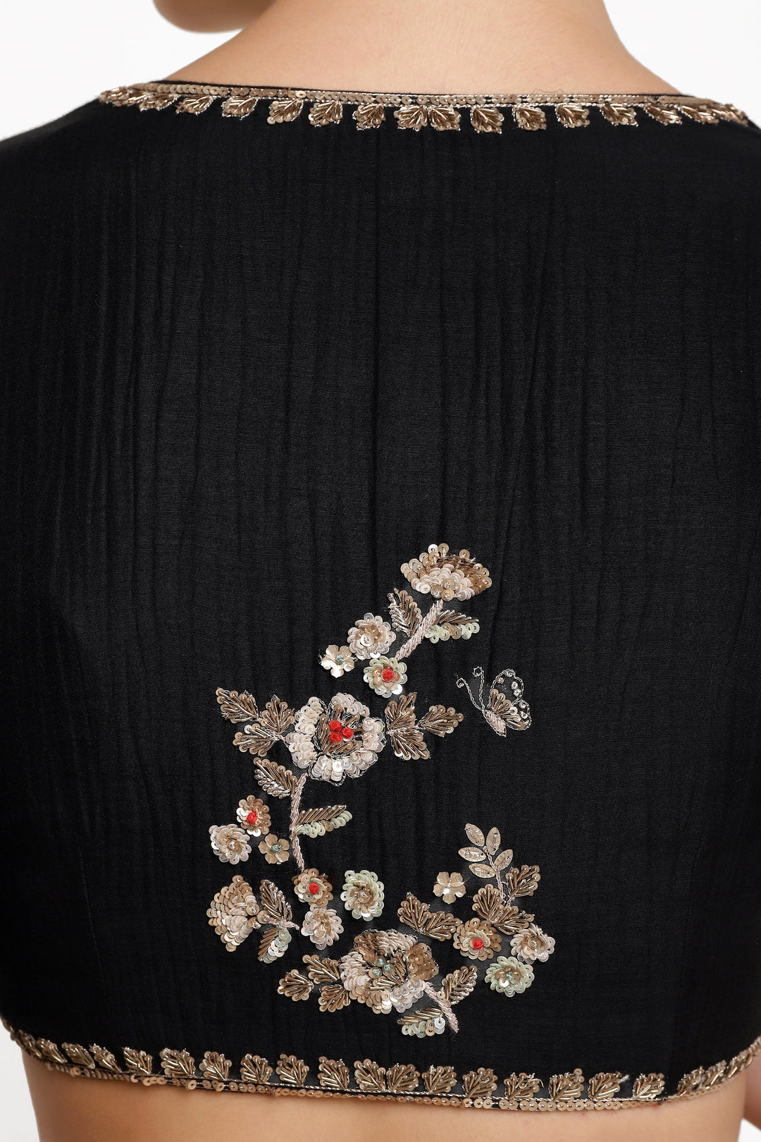 Black blouse with floral embroidery on a white background