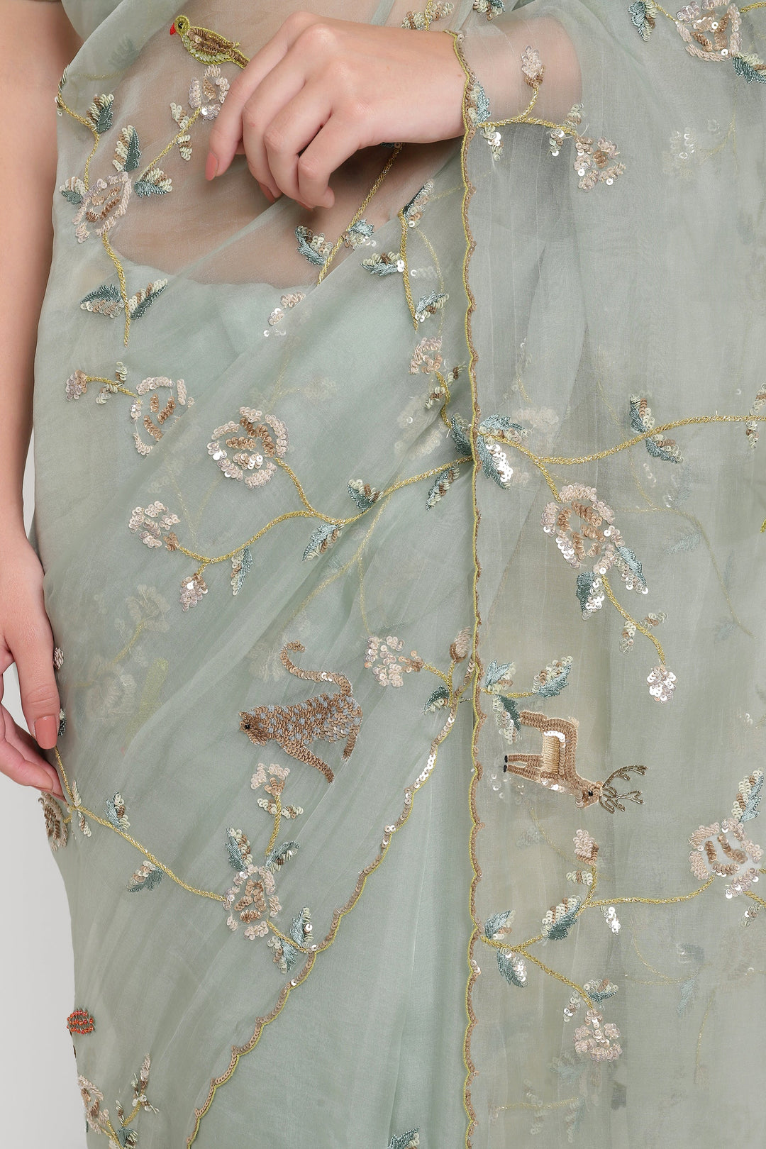 Light green fabric with floral embroidery on a plain background