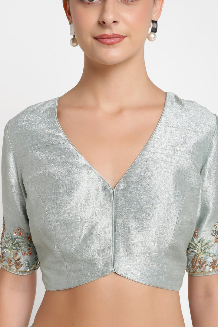 Silver blouse with floral sleeves on a white background