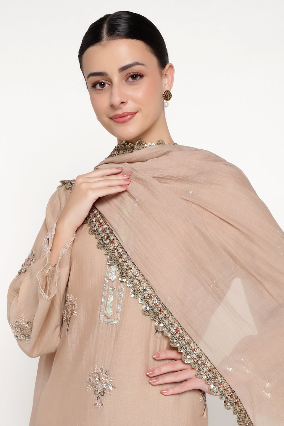 Woman wearing a beige embroidered dupatta on a white background