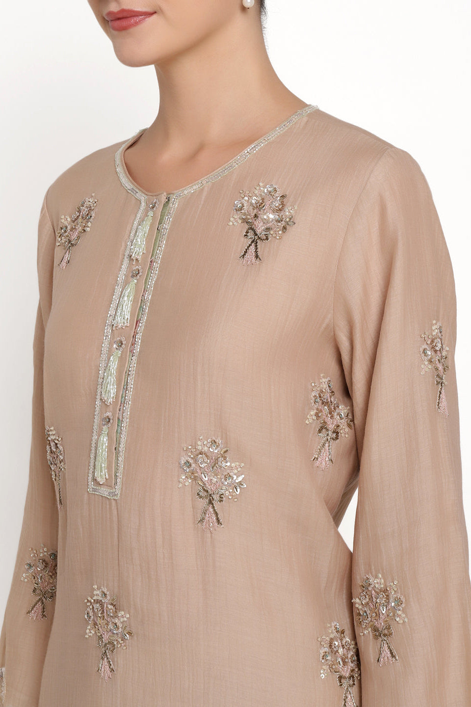 Beige embroidered dress with floral patterns on a white background