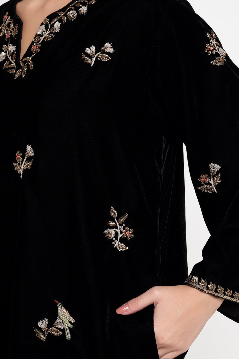 Black embroidered garment with floral patterns on a white background