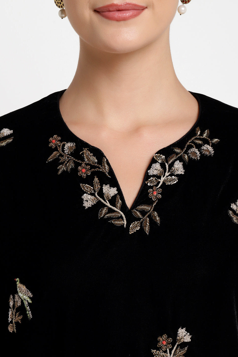 Black embroidered top with floral patterns on a white background