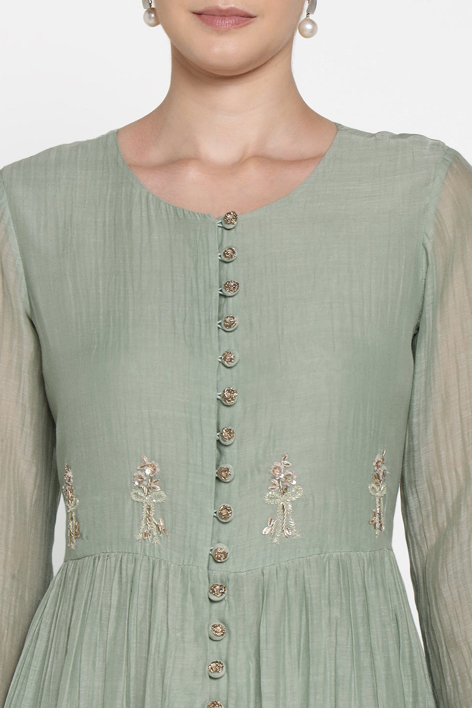 Light green dress with floral embroidery on a plain background