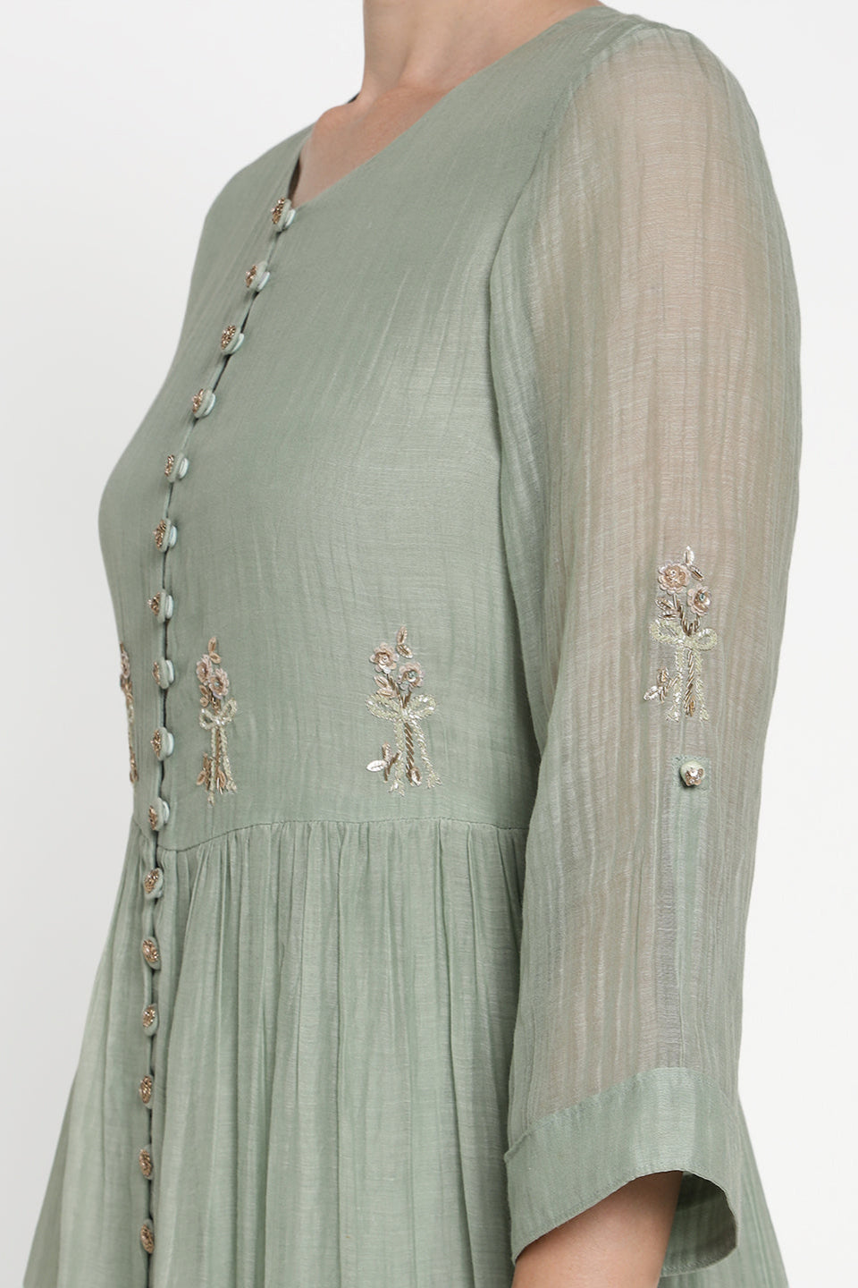 Green dress with floral embroidery on a white background