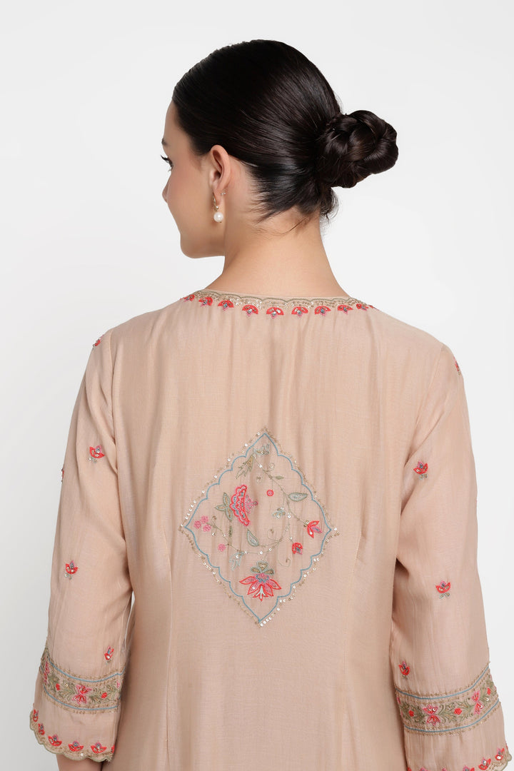 Beige embroidered kurta worn by a person on a white background
