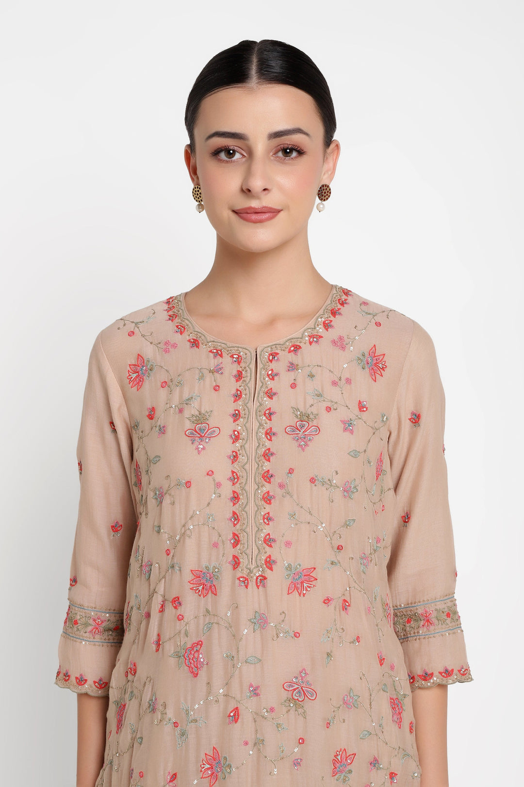 Woman wearing a beige floral dress against a white background