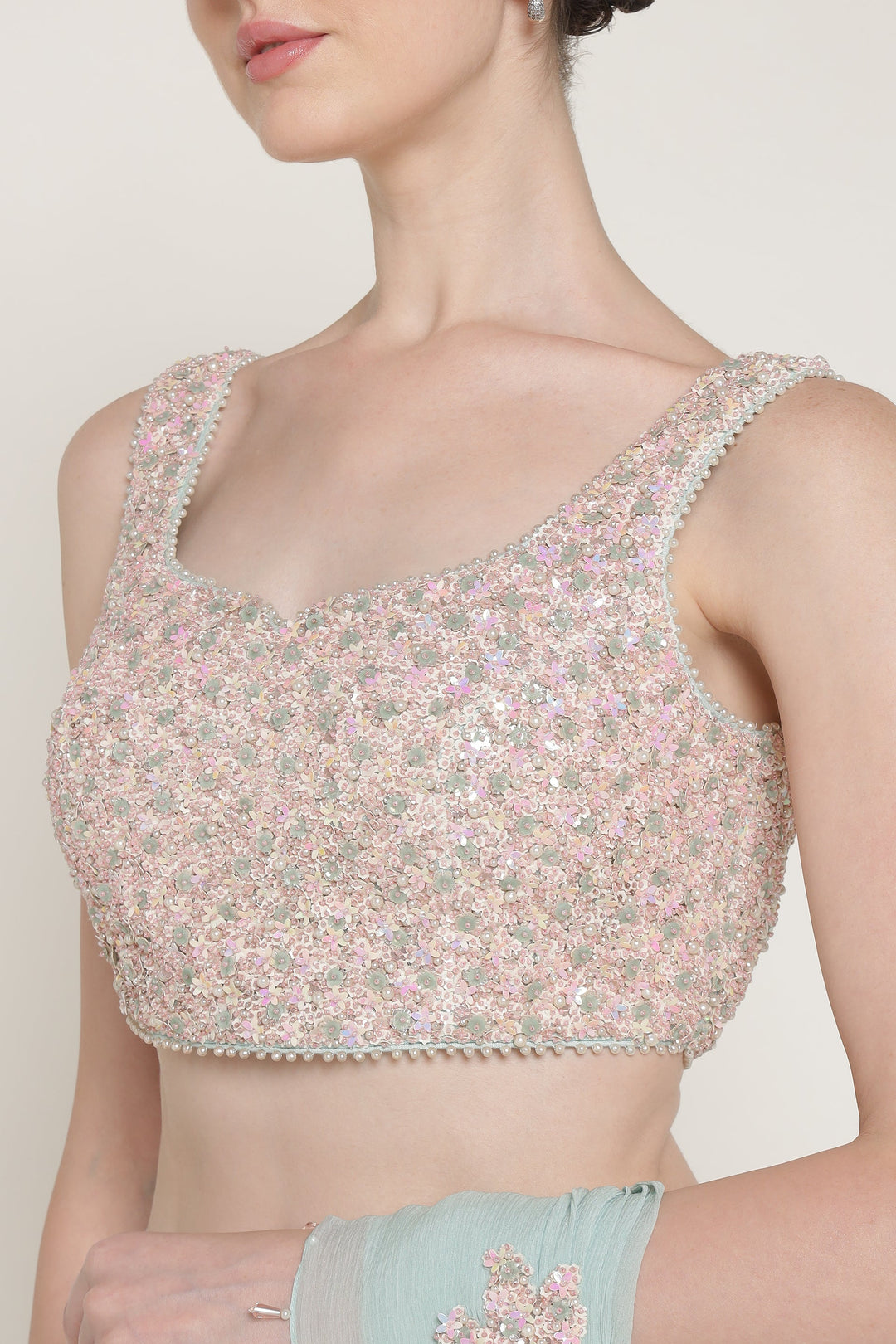 Woman wearing a floral blouse with a plain background