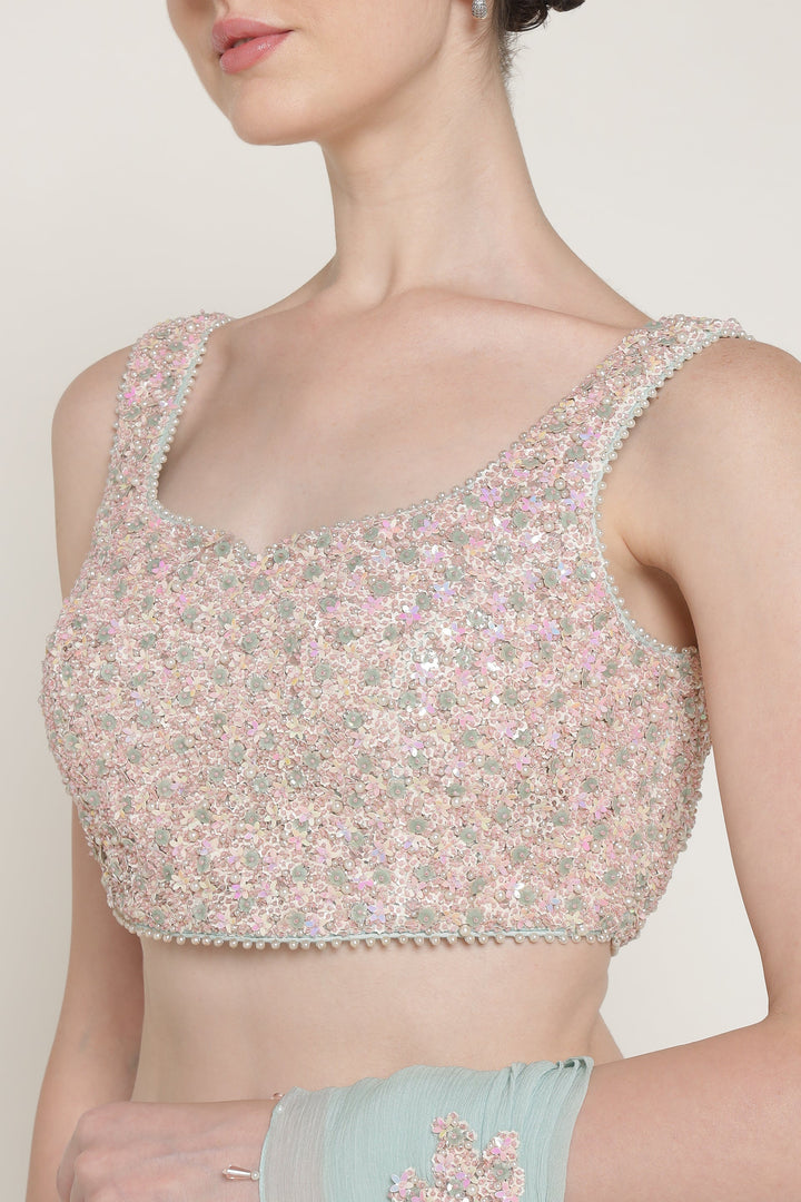 Woman wearing a floral blouse with a plain background