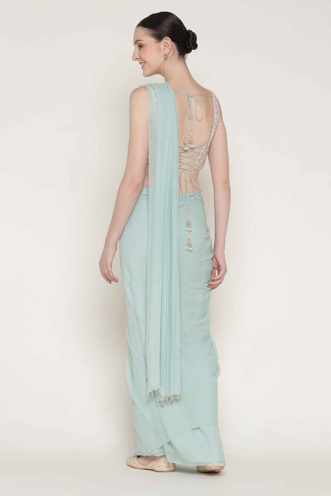 Light blue saree with a subtle design on a plain background