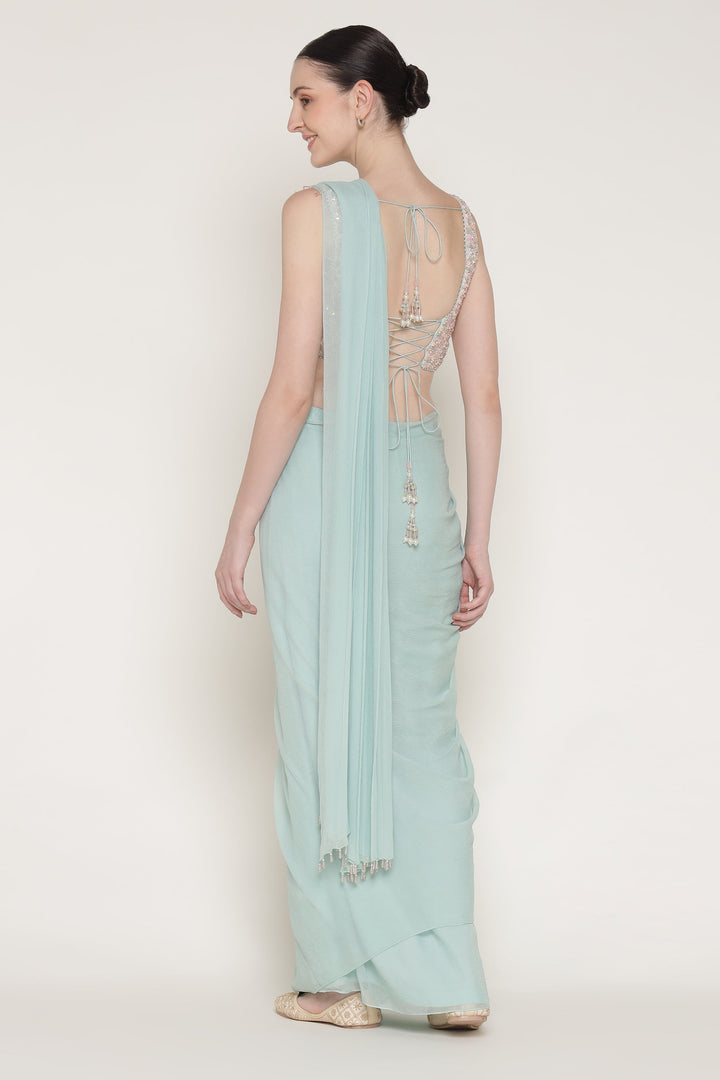 Light blue saree with a subtle design on a plain background