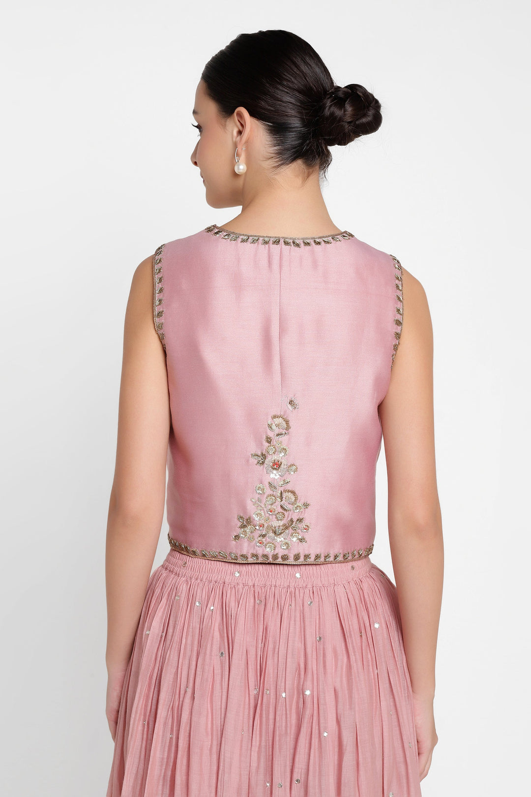 Pink embroidered top and skirt set on a white background