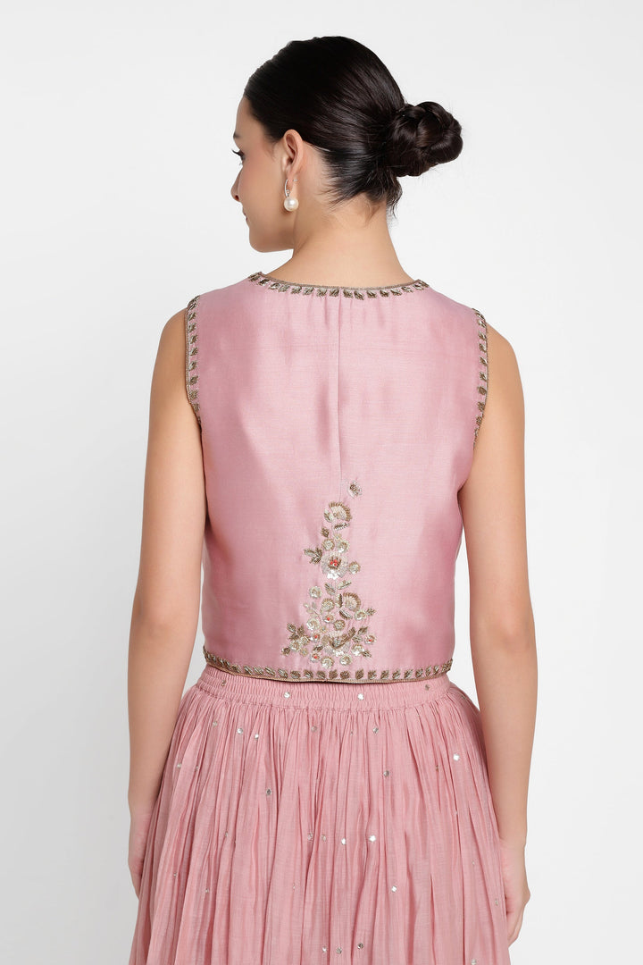 Pink embroidered top and skirt set on a white background