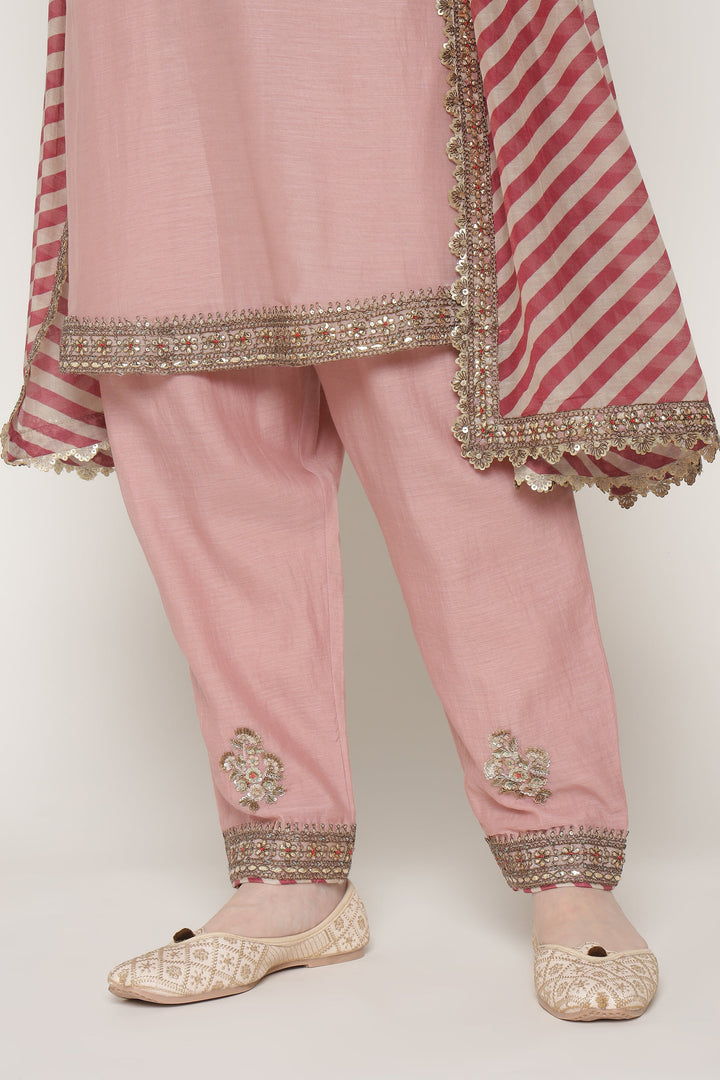 Pink traditional outfit with embroidered details on a white background