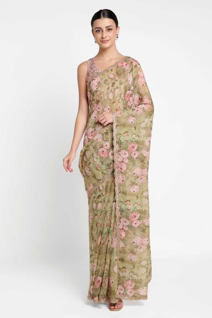 Woman wearing a floral saree with a plain background