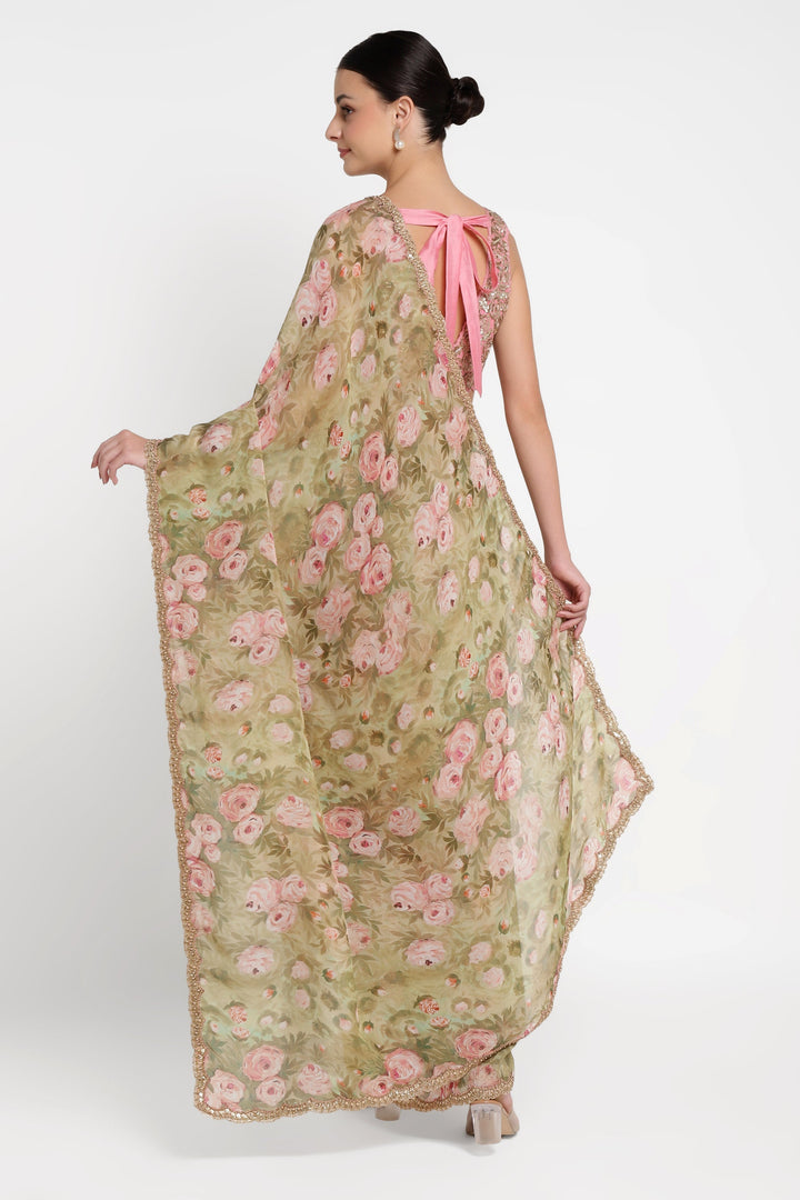 Woman wearing a floral dress with a pink bow on a white background