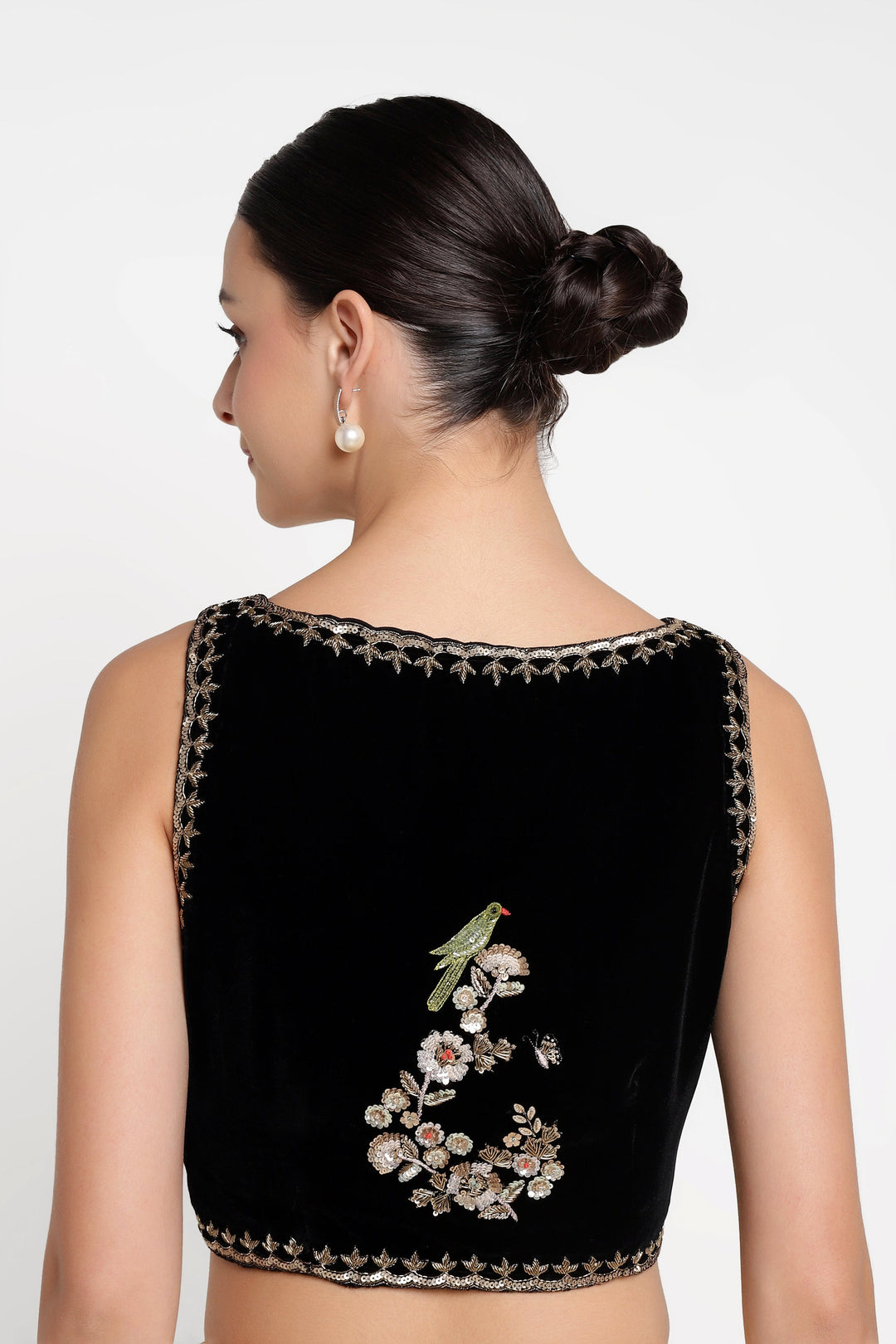 Black blouse with floral embroidery on a white background