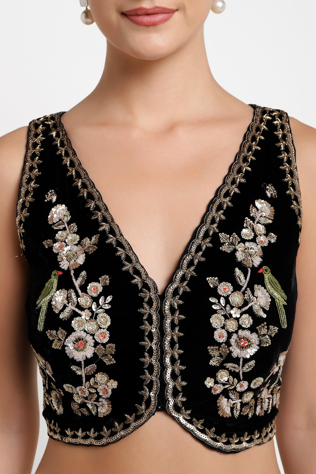 Black embroidered top with floral and bird designs on a white background