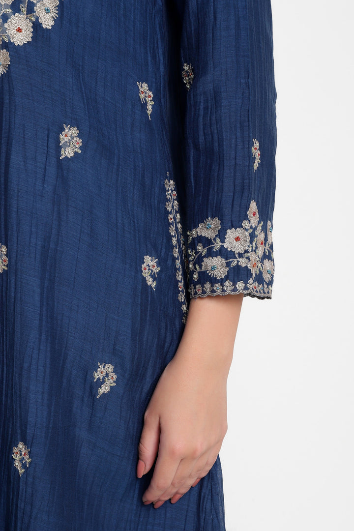 Navy blue dress with floral embroidery on a white background