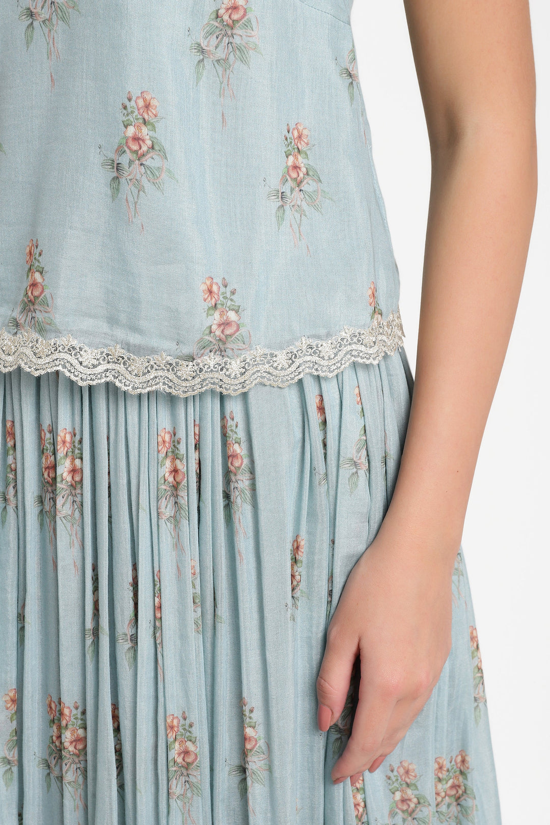 Light blue floral dress with lace trim on a white background