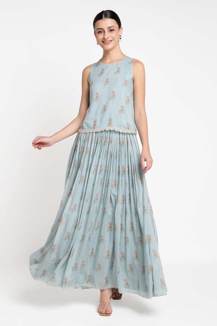 Woman wearing a light blue floral dress on a white background