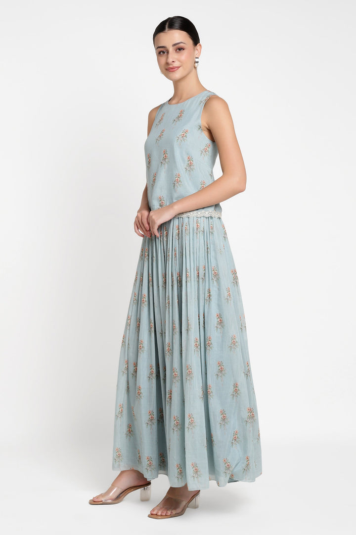 Woman wearing a light blue floral dress on a white background