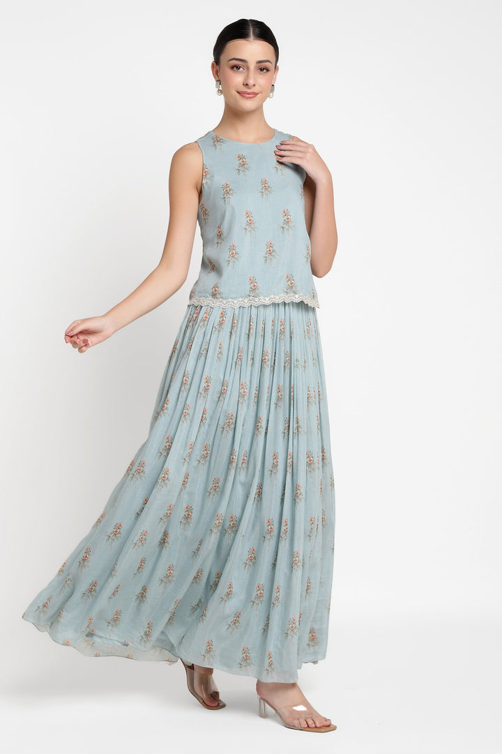 Woman wearing a light blue floral dress on a white background