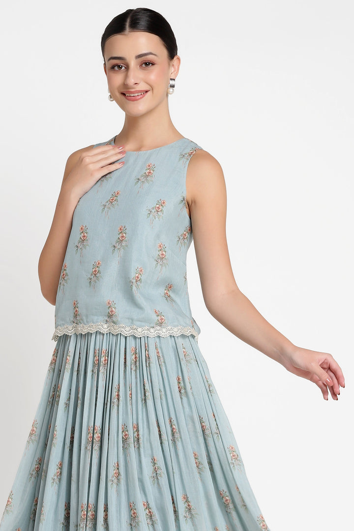 Woman wearing a light blue floral dress on a white background