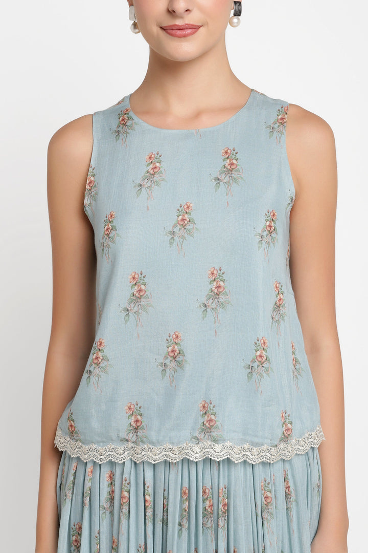 Light blue sleeveless top with floral pattern on a white background