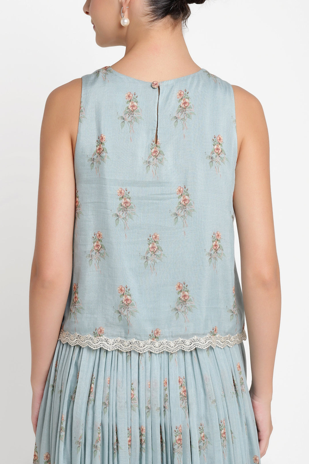Light blue sleeveless dress with floral embroidery on a white background